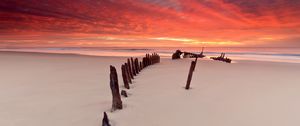 Preview wallpaper stakes, columns, sand, beach, outflow, evening, silence