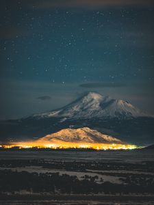 Preview wallpaper starry sky, mountain, snowy, night