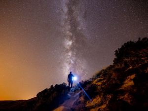 Preview wallpaper starry sky, mountains, man, light