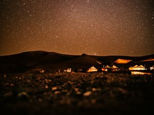 Preview wallpaper starry sky, night, buildings, hills, dark