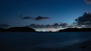Preview wallpaper starry sky, night, horizon, island, stars, shine