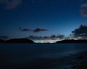 Preview wallpaper starry sky, night, horizon, island, stars, shine