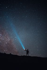 Preview wallpaper starry sky, night, silhouette, light, flashlight