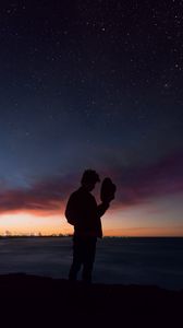 Preview wallpaper starry sky, silhouette, alone, solitude, hat, horizon