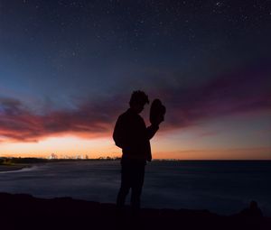 Preview wallpaper starry sky, silhouette, alone, solitude, hat, horizon