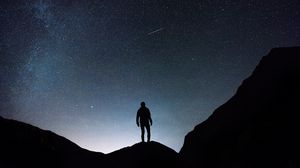 Preview wallpaper starry sky, silhouette, man, rocks