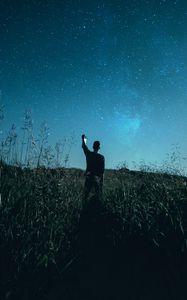 Preview wallpaper starry sky, silhouette, night, grass, field