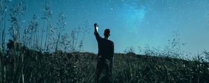 Preview wallpaper starry sky, silhouette, night, grass, field