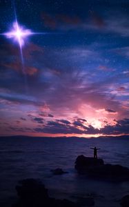 Preview wallpaper starry sky, silhouette, rock, sea, horizon, night