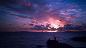 Preview wallpaper starry sky, silhouette, rock, sea, horizon, night