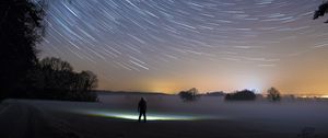 Preview wallpaper starry sky, silhouette, winter, solitude, mist, trees