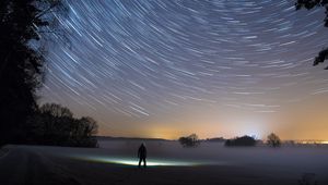 Preview wallpaper starry sky, silhouette, winter, solitude, mist, trees