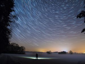 Preview wallpaper starry sky, silhouette, winter, solitude, mist, trees