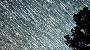 Preview wallpaper starry sky, starfall, stripes, trees, silhouette