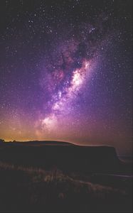 Preview wallpaper starry sky, stars, night, purple, hill, grass