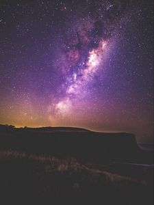 Preview wallpaper starry sky, stars, night, purple, hill, grass