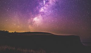 Preview wallpaper starry sky, stars, night, purple, hill, grass