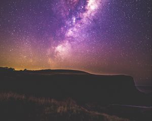 Preview wallpaper starry sky, stars, night, purple, hill, grass