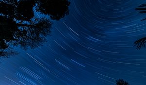 Preview wallpaper starry sky, trees, stars, blur, rotation, long exposure, dark