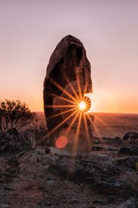 Preview wallpaper stone, rock, sun, sunlight, sunset