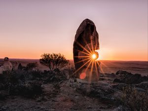 Preview wallpaper stone, rock, sun, sunlight, sunset