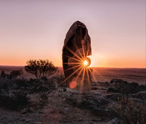 Preview wallpaper stone, rock, sun, sunlight, sunset