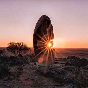 Preview wallpaper stone, rock, sun, sunlight, sunset