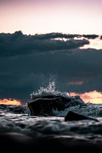 Preview wallpaper stone, spray, clouds, sunset, sea