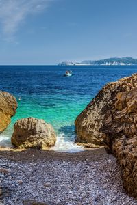 Preview wallpaper stones, beach, sea, pebbles, boat