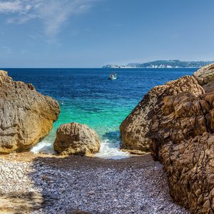 Preview wallpaper stones, beach, sea, pebbles, boat