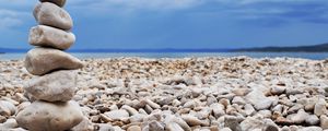 Preview wallpaper stones, coast, beach, figure