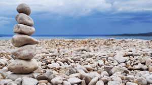 Preview wallpaper stones, coast, beach, figure