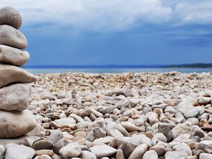 Preview wallpaper stones, coast, beach, figure