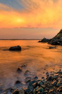 Preview wallpaper stones, coast, fog, rocks, water, decline, evening