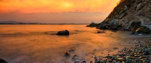 Preview wallpaper stones, coast, fog, rocks, water, decline, evening