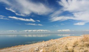 Preview wallpaper stones, coast, grass, sky, clouds, mountains, lake, day