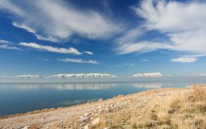 Preview wallpaper stones, coast, grass, sky, clouds, mountains, lake, day