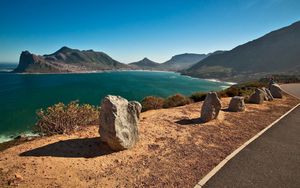 Preview wallpaper stones, coast, road, asphalt, sea