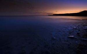 Preview wallpaper stones, coast, twilight, water, fog, mysteriousness