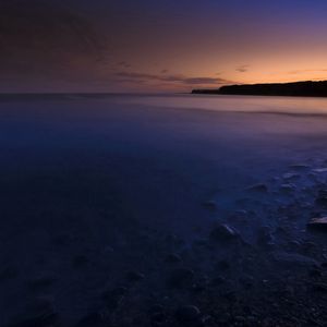 Preview wallpaper stones, coast, twilight, water, fog, mysteriousness