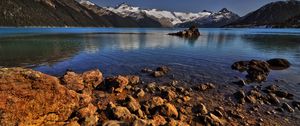 Preview wallpaper stones, coast, water, lake, transparent, mountains