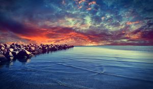 Preview wallpaper stones, construction, sea, breakwater, water, bottom, stains, small, clouds, evening, decline, horizon