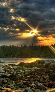 Preview wallpaper stones, evening, sun, beams, clouds, wood, lake, cloudy