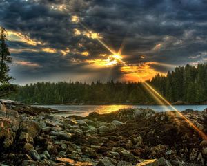 Preview wallpaper stones, evening, sun, beams, clouds, wood, lake, cloudy