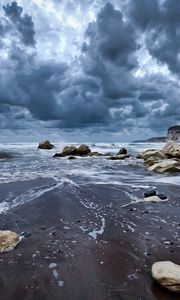 Preview wallpaper stones, foam, sea, clouds, sky, gloomy, sand, wet, cloudy