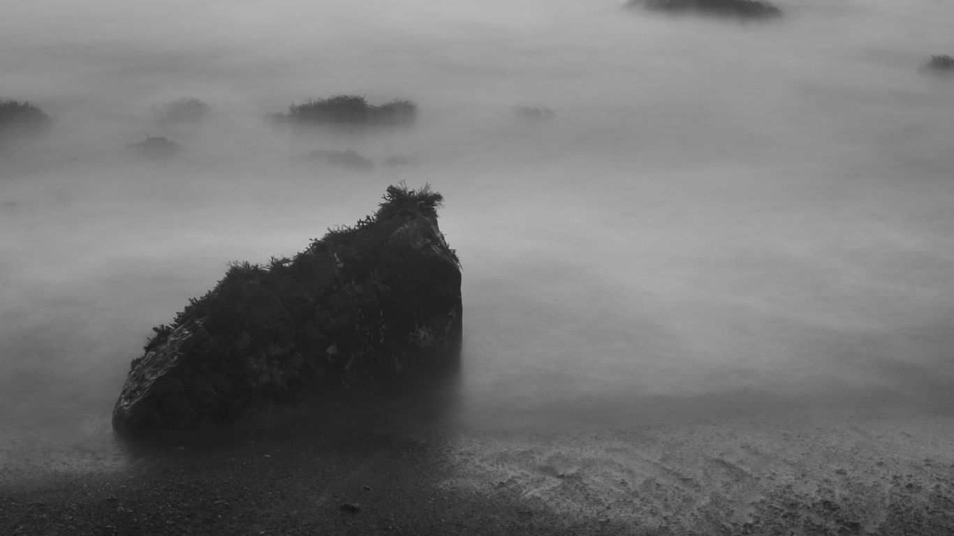 Download Wallpaper 1366x768 Stones, Fog, Sea, Black And White Tablet 