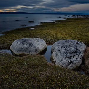 Preview wallpaper stones, grass, shore, sea, twilight