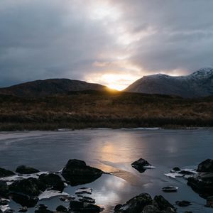 Preview wallpaper stones, lake, grass, hills, sunset