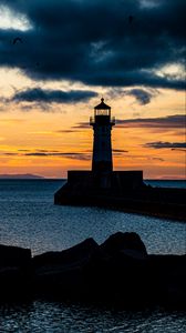 Preview wallpaper stones, lighthouse, silhouette, sea, twilight