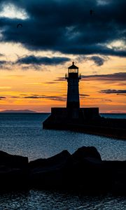 Preview wallpaper stones, lighthouse, silhouette, sea, twilight
